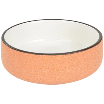 Bol de nourriture pour animaux en céramique avec un extérieur orange texturé et un intérieur blanc lisse, présentant un bord foncé.