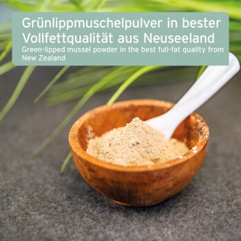 Grünlippmuschelpulver in einer Holzschüssel mit einem weißen Löffel, umgeben von grünem Gras, beschriftet mit deutschem und englischem Text.