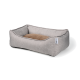 Un lit pour animaux de compagnie gris confortable avec un coussin marron doux au centre, avec des bords surélevés pour le soutien.