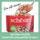 Schesir tuna with shrimps pet food pouch with spoonful of tuna and shrimp fillets, labeled "Added Vitamins" and "Natural fillets."