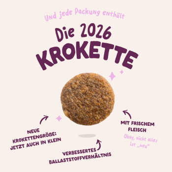 Runde Tierkrokette mit deutschem Text 'Die 2026 KROKETTE', 'Neue Größe: Jetzt auch in klein', 'Mit frischem Fleisch'.
