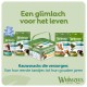 Verpakking en bus Whimzees hondentandkauws met Nederlandse tekst 'Een glimlach voor het leven' en 'Kauwsnacks die verzorgen'