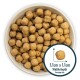 A bowl filled with small, round pet food kibbles, each measuring approximately 1.1cm in width and depth.