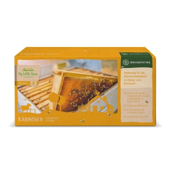 Box mit 'Mein kleiner Bauernhof' Bienenstockrahmen, mit einer Wabe mit Bienen, und Text, der Verwendung und Materialien auf Deutsch beschreibt.