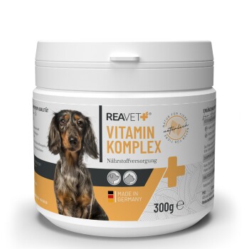 Behälter mit REAVET Vitamin Komplex für Hunde, mit einem Dackel auf dem Etikett, mit den Texten "Nährstoffversorgung" und "Made in Germany".