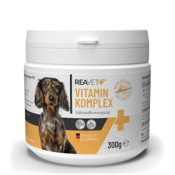 Behälter mit REAVET Vitamin Komplex für Hunde, mit einem Dackel auf dem Etikett, mit den Texten "Nährstoffversorgung" und "Made in Germany".