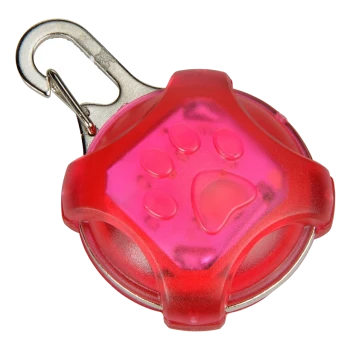 Une lumière de sécurité pour animaux de compagnie rose vif avec un design de patte, avec un clip en métal pour l'attacher.