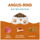 Hundefutter in einer weißen Schüssel mit Pfotenabdrücken, mit dem Text "Angus-Rind Getreidefrei", 50% Angus, 26% Süßkartoffel und Gemüse.
