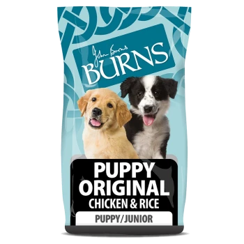 A bag of Burns Puppy Original dog food featuring a golden retriever and a black and white puppy on the front, labeled "PUPPY ORIGINAL CHICKEN & RICE."