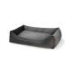 Gray pet bed with a soft, plush surface and raised edges for comfort, featuring a small leather tag on the side.