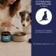 Eine Nahaufnahme eines Hundes, der an einem Beutel "Libido Balance Powder" für Haustiere schnüffelt, mit Dosierungsanweisungen und Vorteilen in deutschem Text.
