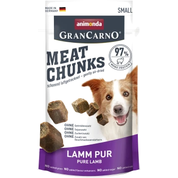 Animonda GranCarno Fleischstücke für Hunde, mit einem lächelnden Hund und Etiketten für "97% Mono-Protein" und "reines Lamm", ohne Getreide oder Zusatzstoffe.