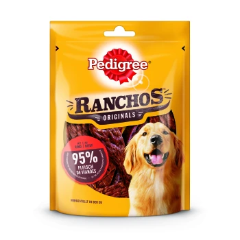 Eine leuchtend gelbe Verpackung von Pedigree Ranchos Originals Hundeleckerlis mit einem lächelnden Golden Retriever und einem Etikett mit der Aufschrift '95% Fleisch de Viandes.'
