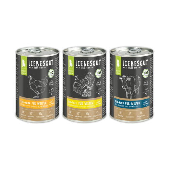 Drei LIEBESGUT-Dosen Welpenfutter mit den Aufschriften Bio-Huhn, Bio-Pute, Bio-Rind, schwarzen Etiketten und weißen Tierskizzen.