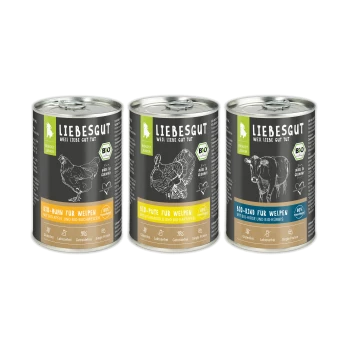 Drei LIEBESGUT-Dosen Welpenfutter mit den Aufschriften Bio-Huhn, Bio-Pute, Bio-Rind, schwarzen Etiketten und weißen Tierskizzen.