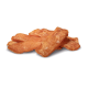 Une pile de bandes de viande séchée orange, ressemblant à des friandises pour chiens, disposées sur un fond blanc.