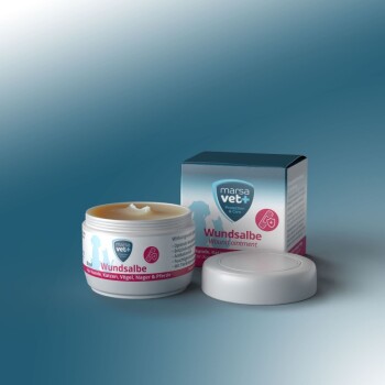 Wundsalbe in einem weißen Glas mit der Aufschrift "Wundsable" mit einem pinken und blauen Design, neben seiner Schachtel, geeignet für Hunde, Katzen und andere Haustiere.
