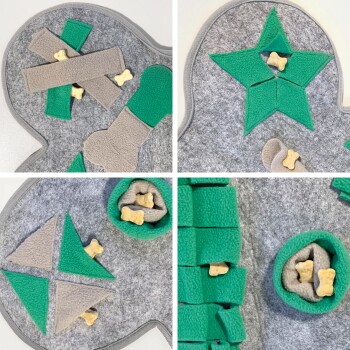 Eine Person fügt Leckerlis zu einer grün-grauen, knochenförmigen Hundepuzzle-Matte hinzu, mit einem Hund in der Nähe. Merkmale: maschinenwaschbar, rutschfester Boden.