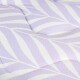 Close-up of a lavender and white patterned cushioned pet bed with a leaf design.