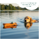 Oranger rechteckiger Hundetrainingsdummy mit Seilgriff und „Rommers“-Etikett.