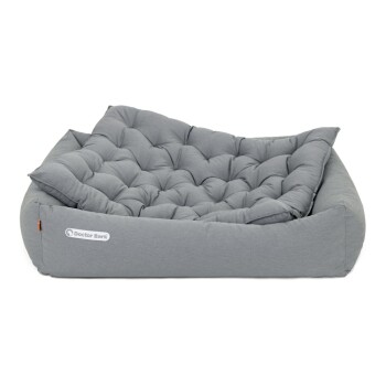 Graues Haustierbett mit gepolstertem Design und einer weichen, gepolsterten Oberfläche, mit dem Logo "Doctor Bark" an der Seite.