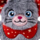 Close-up of a gray plush cat toy with blue eyes, a pink nose, and a red polka-dot collar with stars.