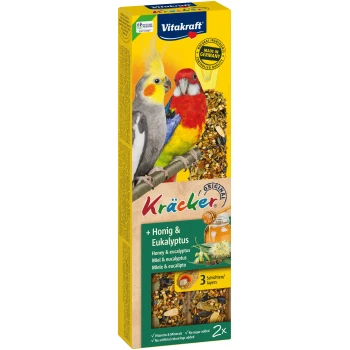 Vitakraft Kräcker Vogel-Leckerli-Box mit zwei bunten Vögeln, einem grauen Nymphensittich und einem rot-gelben Wellensittich, mit Honig- und Eukalyptusgeschmack.