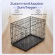 Schwarzer klappbarer Metall-Haustierkäfig auf Holzboden mit deutscher Überschrift 'Zusammenklappbar Zum Tragen'.