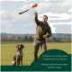 Oranger Stoffdummy für Hundetraining mit grünem Griff und "Rommers"-Etikett an einer Schnur befestigt.