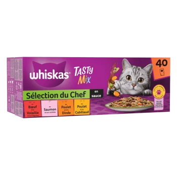 Boîte de nourriture pour chats Whiskas Tasty Mix avec un chat gris aux yeux brillants, présentant diverses saveurs : bœuf, saumon, poulet et morue en sauce.