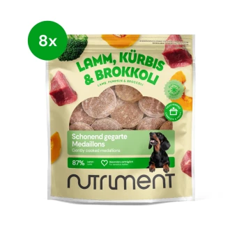 Lamm-, Kürbis- und Brokkoli-Hundeleckerlis in einem wiederverschließbaren Beutel, mit einem Dackel und dem Text "87% Lamm" und "Sanft gekochte Medaillons."
