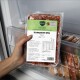 Hand hält vakuumverpackte 'Komplett‑Mix Rind' Barfer's Complete 500‑g Hundefutterpackung im Gefrierschrank.