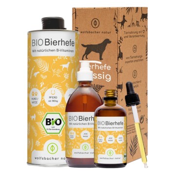 Haustierergänzungen in einer Box mit Hundesilhouetten: ein gelber "BIO Bierhefe" Behälter, zwei braune Flaschen und eine Pipette.