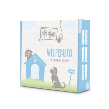 Cage pour chiots 6 x 200 g Emballage de Mjamjam Welpenbox présentant une maison de chien bleue, des illustrations de chiens joueurs, et le texte "WELPENBOX WILKOMMEN DAHEIM!"