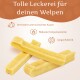 Hund liegt auf einem Bett mit Text über natürliche Zahnpflege, Reduzierung von Zahnstein und Mundgeruch sowie Stärkung der Kaumuskulatur.