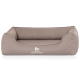 Ein plüschiges, taupefarbenes Hundebett mit erhöhten Seiten und einem weißen 'KNUFFELWUFF'-Logo auf der Vorderseite, das für den Komfort von Haustieren entworfen wurde.