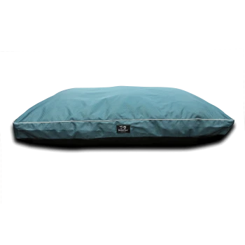 Rectangular teal pet bed cushion with white piping, black base and visible "Beddies" label