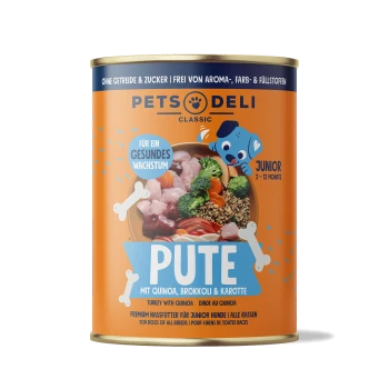 Karma w puszce dla psów "Pute" z quinoa, brokułami i marchewką. Etykiety: "Für ein gesundes Wachstum," "Junior 2-12 Monate," "Premium Nassfutter."
