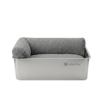 Rechteckiges Katzenbett aus Edelstahl mit grauem, strukturiertem Kissen und linkem Seitenpolster, 'Lucky-Kitty'-Logo auf der Vorderseite.