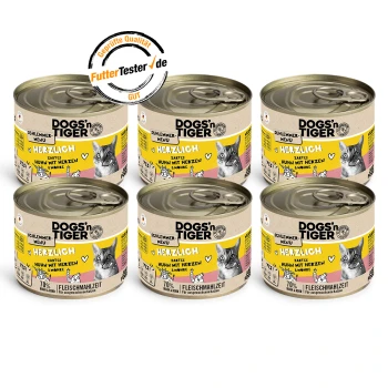 Sechs Dosen DOGS'n TIGER Katzenfutter, beschriftet mit "Herzlich", mit Huhn, Herzen und Karotten, mit einem Qualitätssiegel von FutterTester.de.