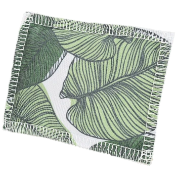 A pet blanket featuring a green leaf pattern with white stitching along the edges.