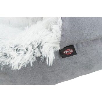 Graues Haustierbett mit einem flauschigen weißen Innenraum und einem schwarzen Etikett mit der Aufschrift "TRIXIE" an der Seite.