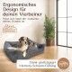 Ergonomisches Hundebett in einem gemütlichen Raum, mit einem plüschigen Design und einer Memory-Schaumfüllung, mit Text, der Komfort und anatomische Passform hervorhebt.