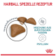 Braune, dreieckige Katzenfutterkibbles mit dem Text "HAIRBALL SPEZIELLE REZEPTUR," der die Mischung aus Ballaststoffen und Flohsamen hervorhebt.