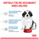 Ein flauschiger Welpe sitzt neben einer roten Schüssel mit Hundefutter, mit Text über Gesundheitsvorteile: Unterstützung des Immunsystems, kontrollierte Energie und Mikrobiomgesundheit.