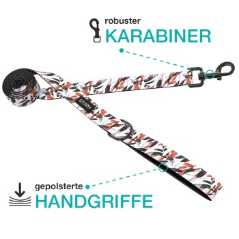 Eine bunte Hundeleine mit einem robusten Karabiner und gepolsterten Griffen, mit einem stilvollen Muster in Rot, Schwarz und Weiß.