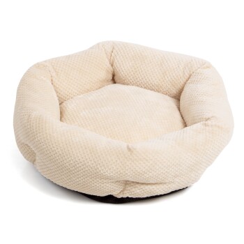 Ein weiches, rundes Haustierbett in cremigem Beige mit einer strukturierten Oberfläche und plüschigen Seiten, ideal für kleine Hunde oder Katzen.