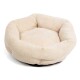 Ein weiches, rundes Haustierbett in cremigem Beige mit einer strukturierten Oberfläche und plüschigen Seiten, ideal für kleine Hunde oder Katzen.