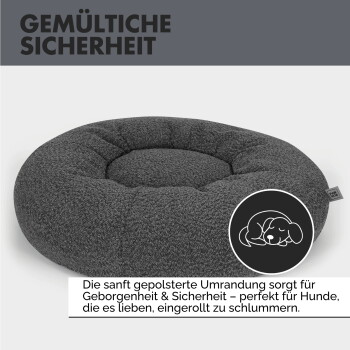 Rundes, plüschiges Haustierbett aus strukturiertem dunkelgrauem Stoff, mit einem gepolsterten Zentrum und einem kleinen Etikett mit der Aufschrift "Pfote."