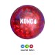 Balle jouet KONG translucide rouge pour chien avec picots surélevés et logo blanc «KONG» ; petites variantes bleue, verte et rouge en dessous sur fond noir.
